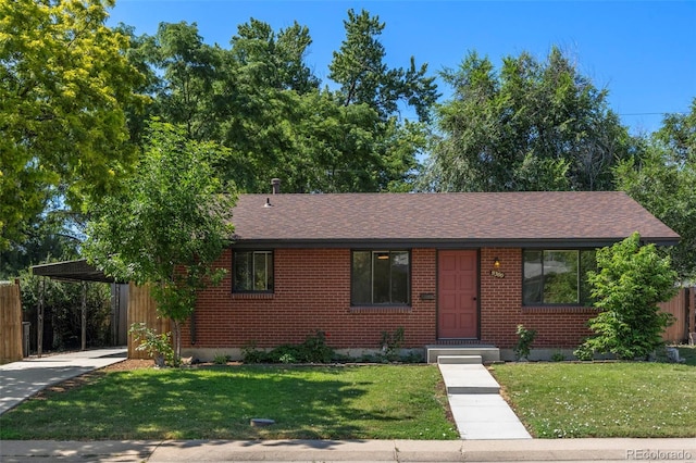 9300 W 53rd Ave, Arvada, CO 80002 - view of front facade featuring brick siding, an attached carport, and a shingled roof