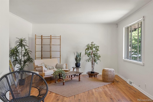 9300 W 53rd Ave, Arvada, CO 80002 - living area featuring wood finished floors and ornamental molding