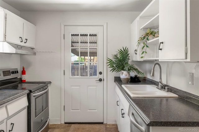 9300 W 53rd Ave, Arvada, CO 80002 - kitchen with appliances with stainless steel finishes, under cabinet range hood, open shelves, and dark countertops