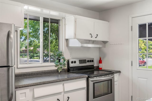 9300 W 53rd Ave, Arvada, CO 80002 - kitchen with stainless steel appliances, under cabinet range hood, dark countertops, and white cabinets