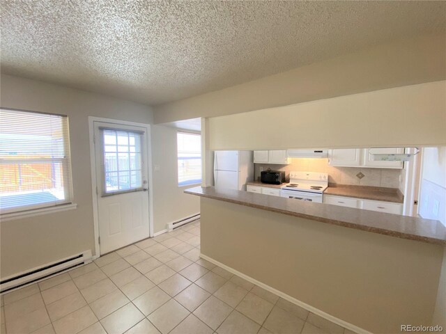 kitchen featuring white appliances, ventilation hood, white cabinetry, and a baseboard heating unit