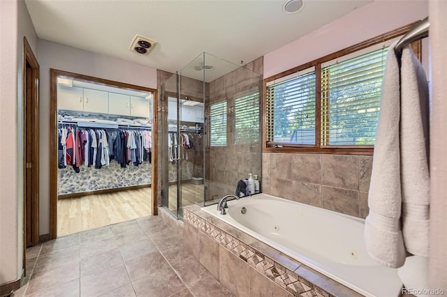 7043 S Owens Way, Littleton, CO 80127 - full bath featuring a shower stall, a jetted tub, and a spacious closet