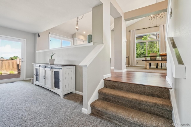7311 Rattlesnake Dr, Lone Tree, CO 80124 - staircase featuring a chandelier, healthy amount of natural light, and carpet flooring