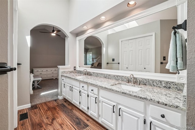 7311 Rattlesnake Dr, Lone Tree, CO 80124 - bathroom with double vanity, wood finished floors, recessed lighting, and ceiling fan