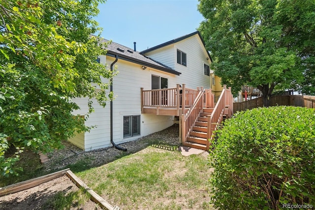 7311 Rattlesnake Dr, Lone Tree, CO 80124 - back of property with stairway, a wooden deck, and roof with shingles