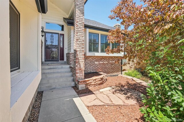 7311 Rattlesnake Dr, Lone Tree, CO 80124 - view of exterior entry featuring brick siding