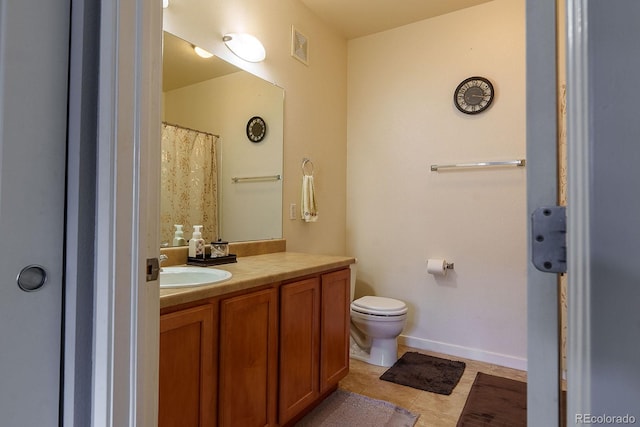 bathroom featuring toilet, vanity, and tile patterned floors