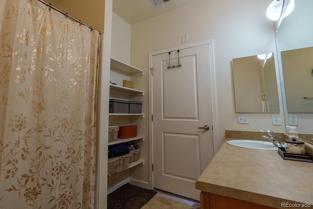 bathroom with tile patterned flooring and vanity