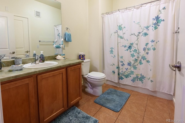 bathroom with tile patterned flooring, vanity, and toilet