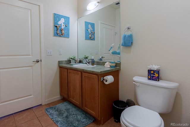 bathroom with tile patterned flooring, vanity, and toilet