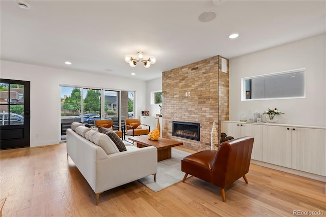 1645 N Osceola St, Denver, CO 80204 - living room with light wood-style floors, a brick fireplace, healthy amount of natural light, and recessed lighting
