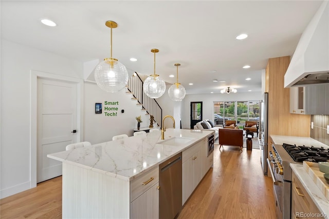 1645 N Osceola St, Denver, CO 80204 - kitchen featuring appliances with stainless steel finishes, custom range hood, recessed lighting, modern cabinets, and light wood-style floors