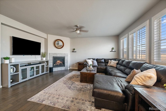 living room with a fireplace, ceiling fan, and dark hardwood / wood-style flooring