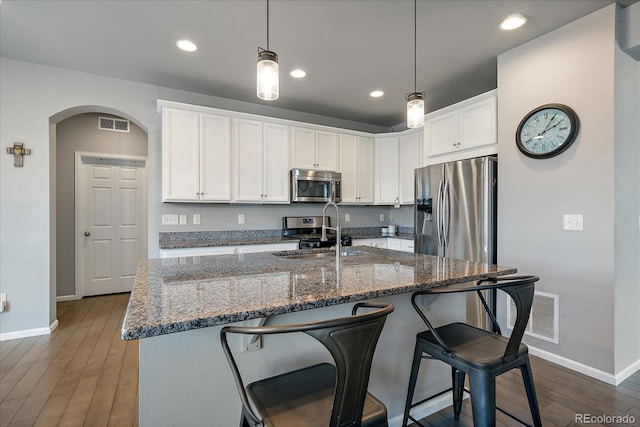 kitchen with sink, white cabinets, dark hardwood / wood-style floors, and appliances with stainless steel finishes