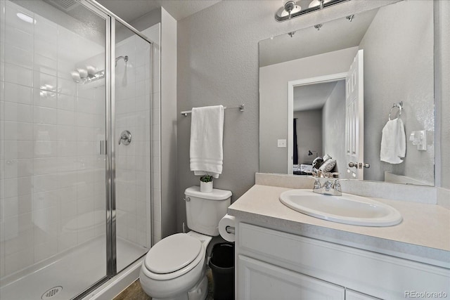 bathroom with vanity, toilet, and walk in shower