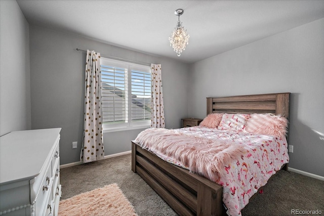 bedroom featuring dark colored carpet and a notable chandelier