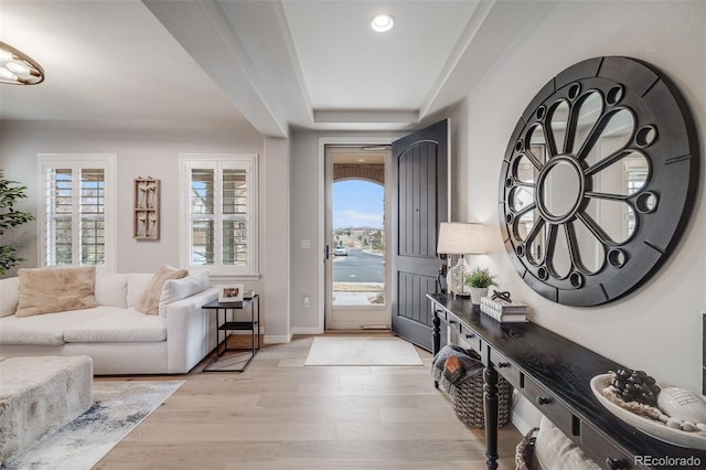 foyer entrance with baseboards, recessed lighting, and light wood-style floors