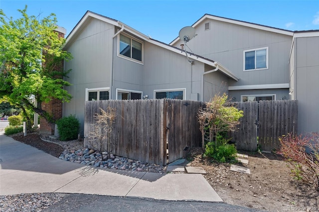 view of side of home featuring fence