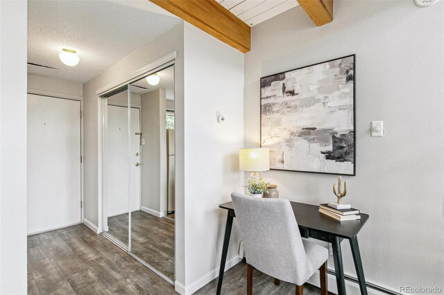 office with baseboards, a textured ceiling, and wood finished floors
