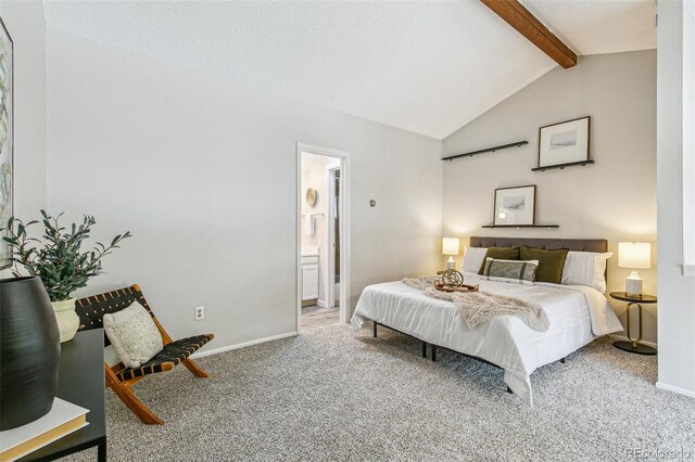 carpeted bedroom with baseboards, vaulted ceiling with beams, and ensuite bathroom
