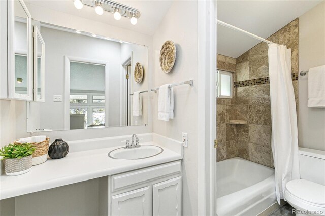 full bath with vanity, plenty of natural light, toilet, and shower / bath combination with curtain
