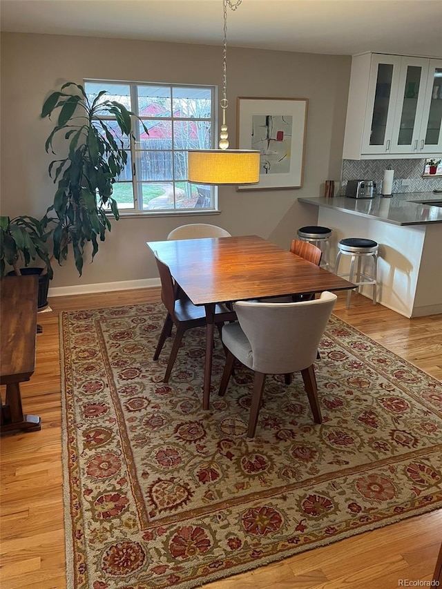 dining space featuring light wood-type flooring