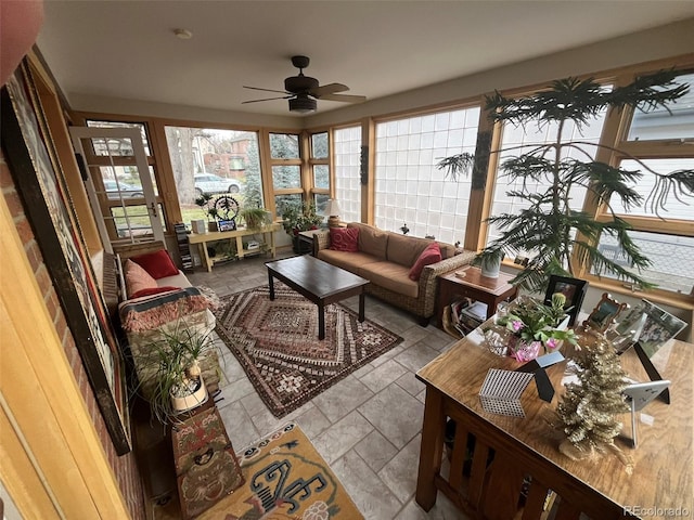 sunroom / solarium featuring ceiling fan and a wealth of natural light