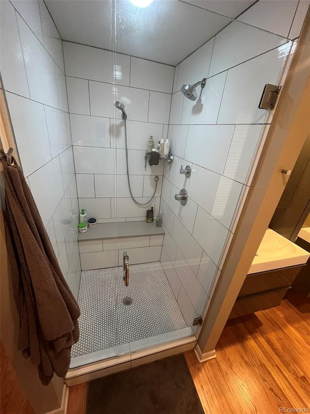 bathroom with walk in shower and wood-type flooring