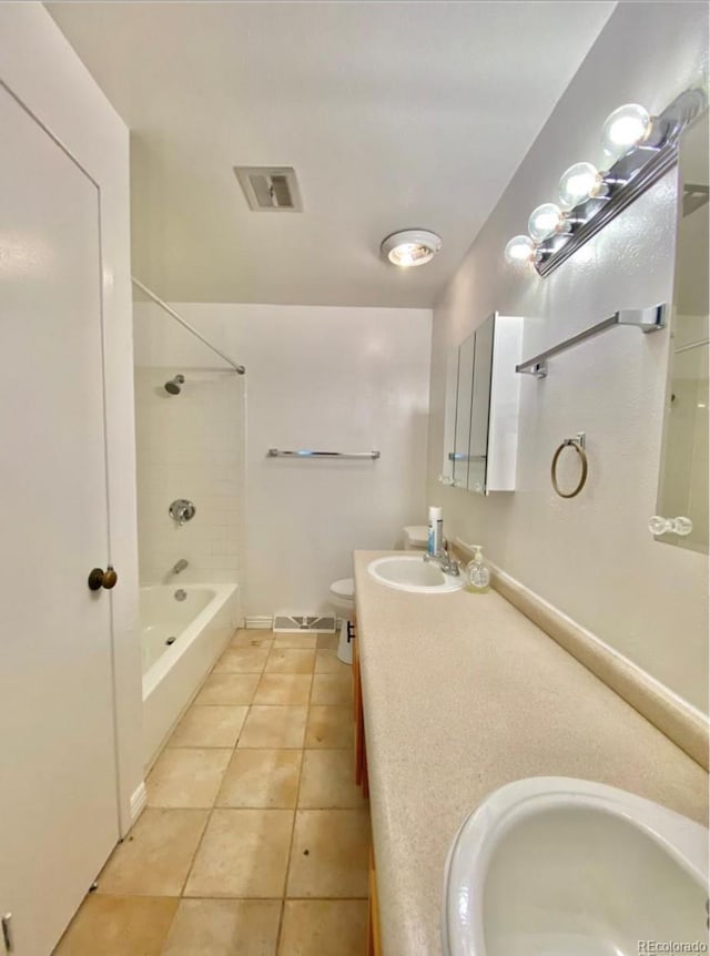 13024 E Alaska Pl, Aurora, CO 80012 - bathroom with tile patterned floors, double vanity, and tub / shower combination