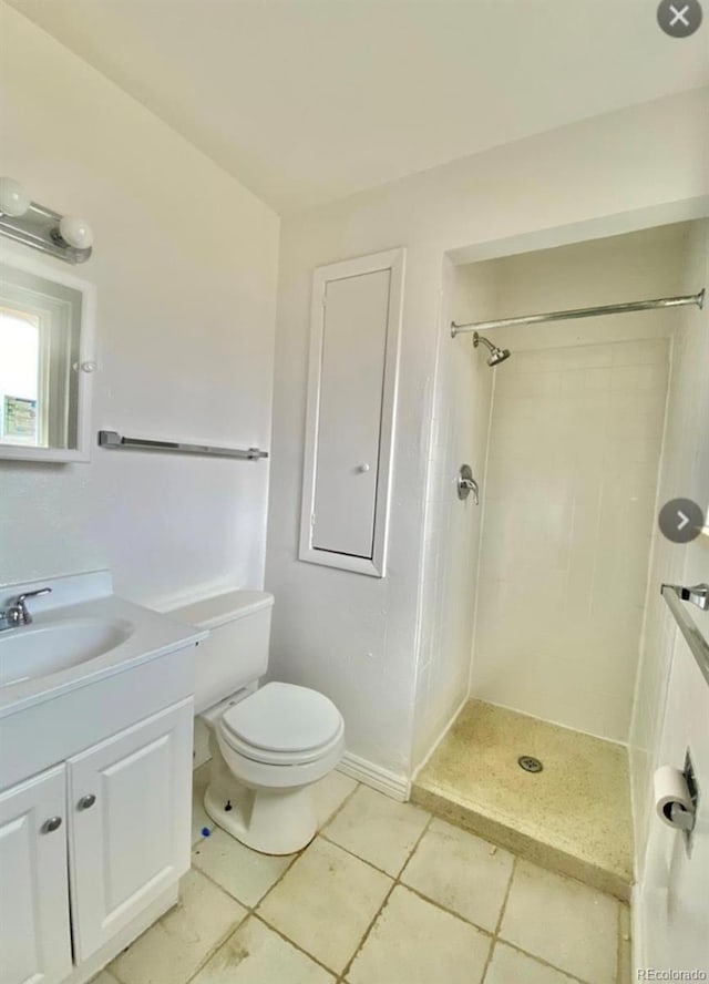 13024 E Alaska Pl, Aurora, CO 80012 - full bath featuring vanity, tiled shower, and tile patterned floors