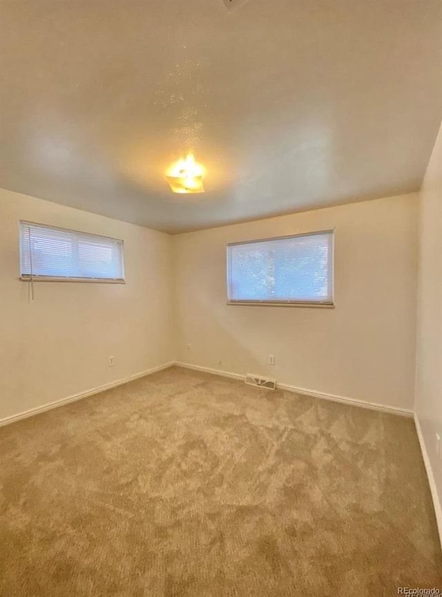 13024 E Alaska Pl, Aurora, CO 80012 - empty room with carpet floors and healthy amount of natural light