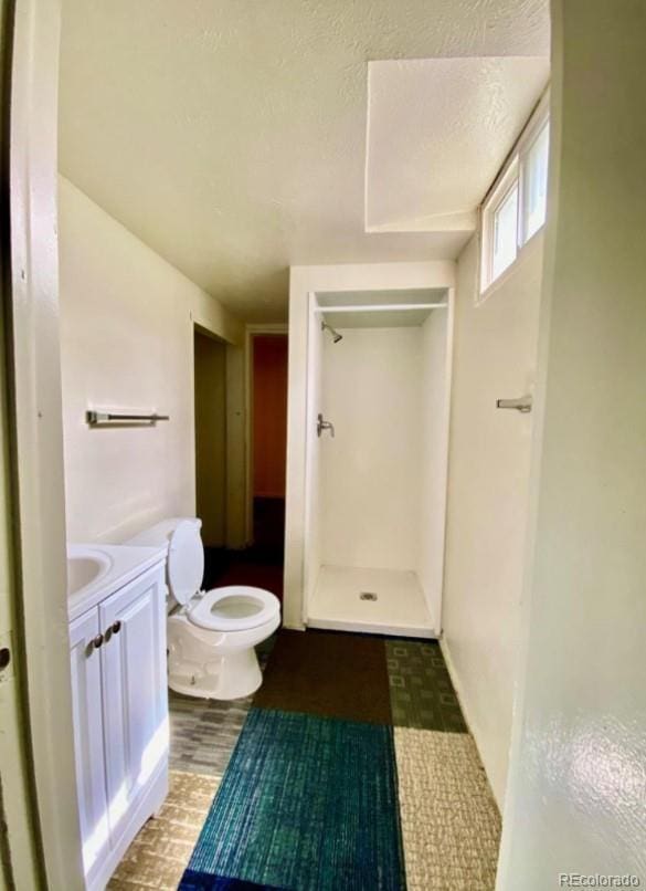 13024 E Alaska Pl, Aurora, CO 80012 - full bath with a stall shower, vanity, and tile patterned floors