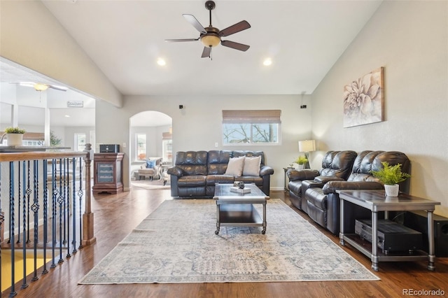 living room featuring lofted ceiling, dark wood-type flooring, and ceiling fan