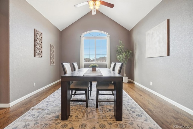 dining area with hardwood / wood-style flooring, vaulted ceiling, and ceiling fan