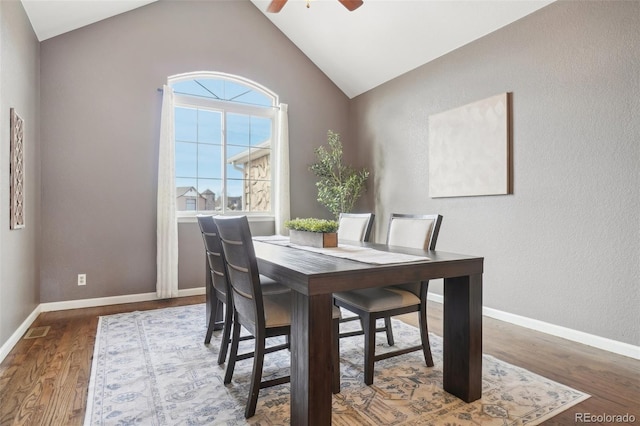 dining area featuring hardwood / wood-style flooring, vaulted ceiling, and ceiling fan