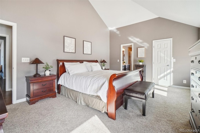 carpeted bedroom with high vaulted ceiling