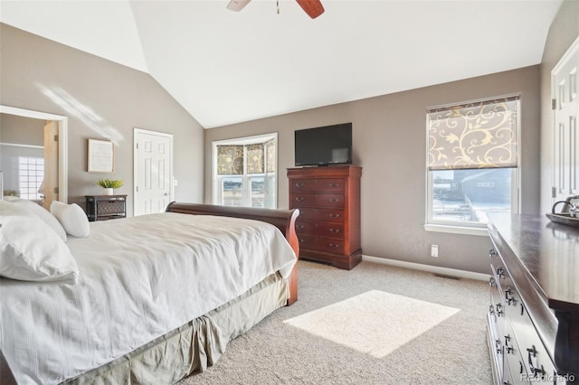 carpeted bedroom featuring lofted ceiling, multiple windows, and ceiling fan