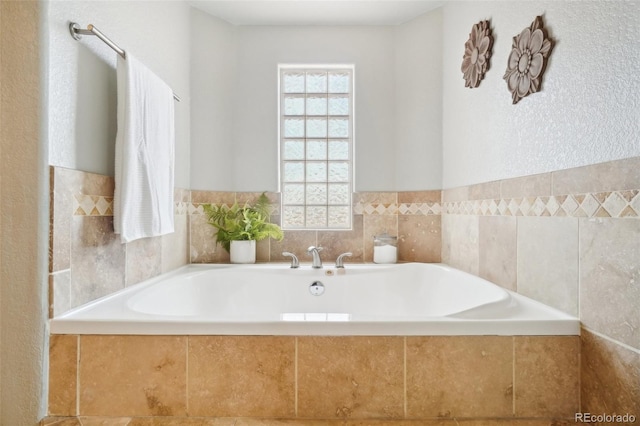 bathroom with a relaxing tiled tub