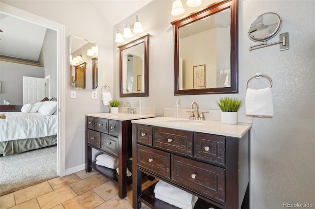 bathroom with vanity, vaulted ceiling, and tile patterned floors