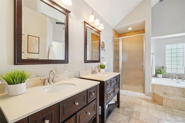 bathroom with shower with separate bathtub, lofted ceiling, and vanity