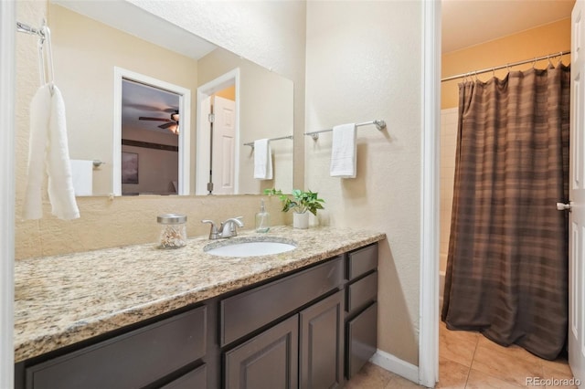 bathroom with shower / bath combination with curtain, vanity, and tile patterned flooring