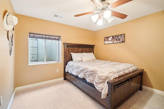 bedroom featuring light carpet and ceiling fan