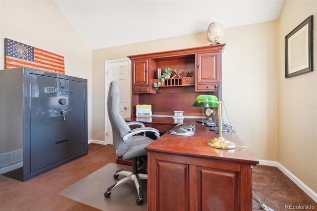 carpeted office space with vaulted ceiling