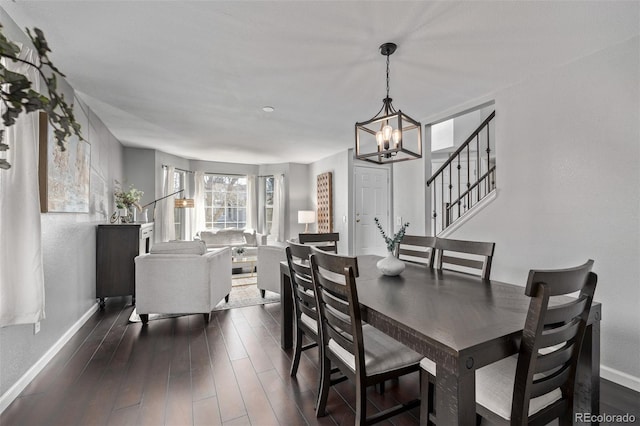 dining space featuring stairway, an inviting chandelier, dark wood finished floors, and baseboards