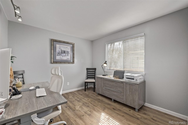 home office featuring light wood-style floors and baseboards