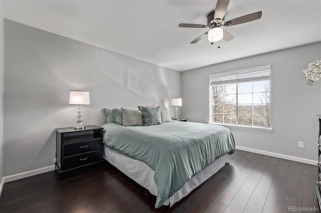 bedroom with baseboards, dark wood finished floors, and a ceiling fan