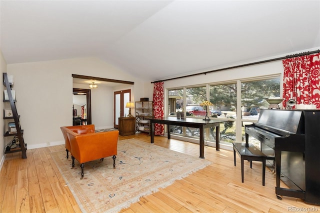 interior space with light wood-type flooring and vaulted ceiling