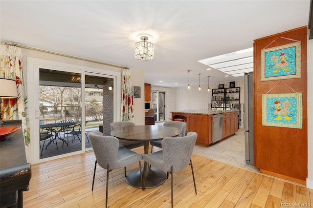 dining room with an inviting chandelier and light hardwood / wood-style floors