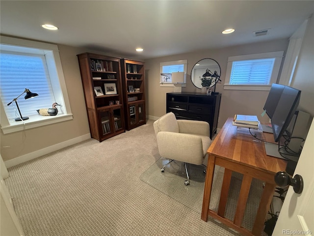 carpeted home office featuring recessed lighting, baseboards, visible vents, and plenty of natural light
