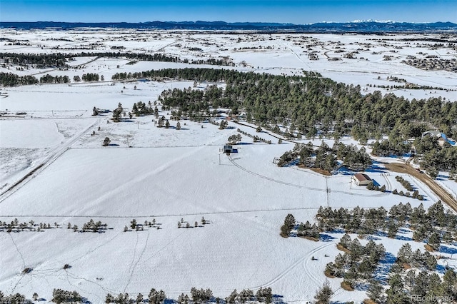 snowy aerial view with a mountain view